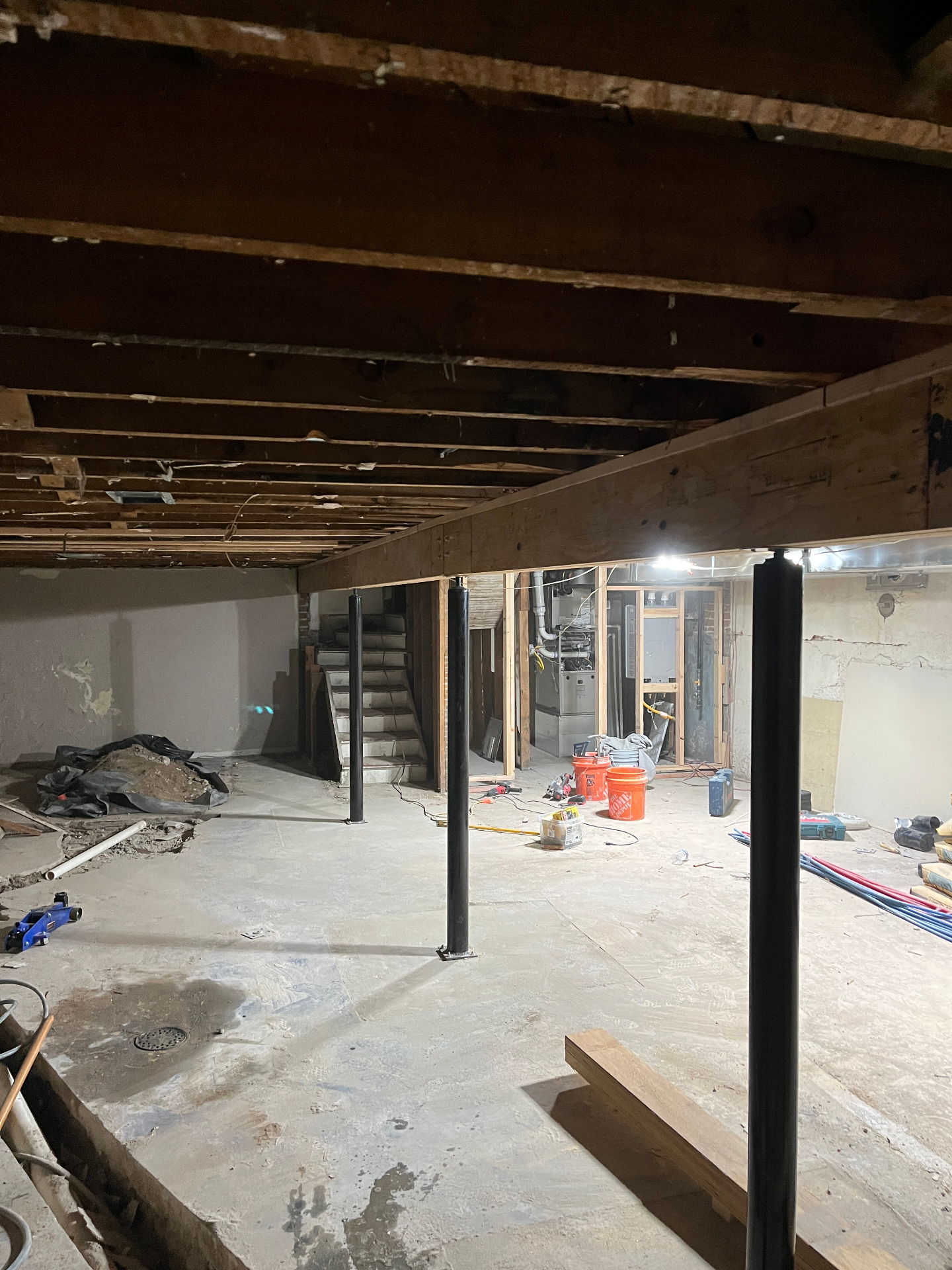 Basement after main beam replacement with new beam and steel support posts in place