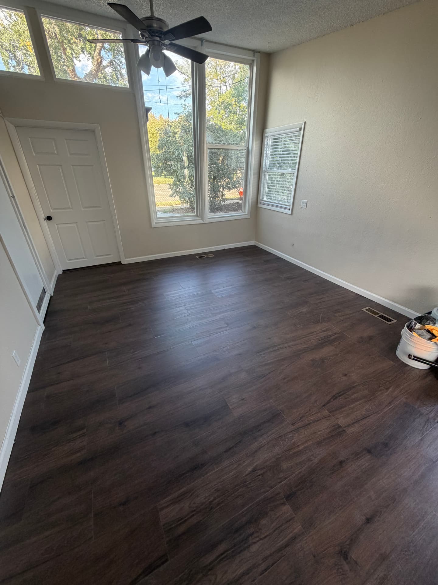 Tall-window living area flooring renovation — After