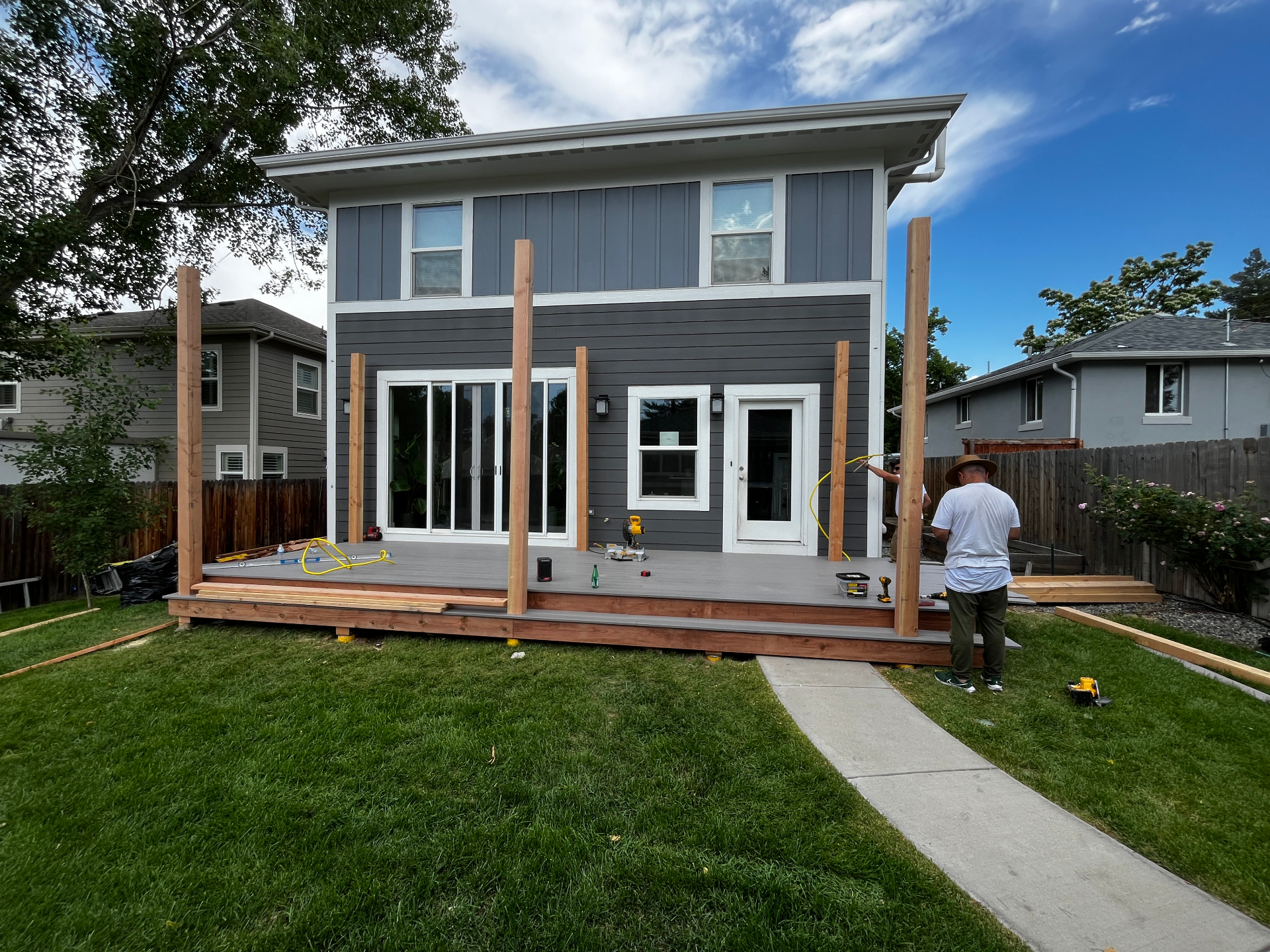 Composite deck with cedar posts going up for a backyard pergola