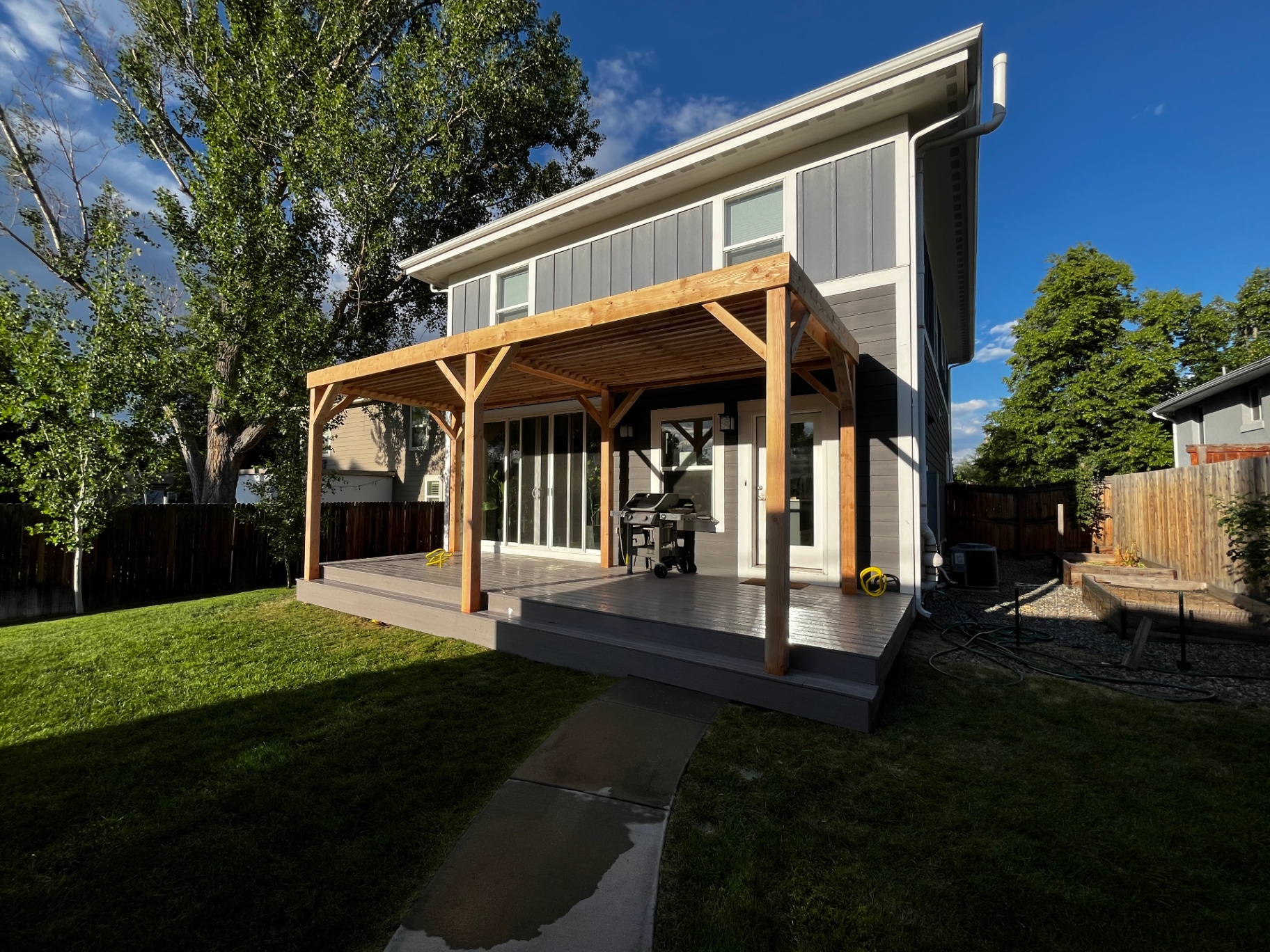 Finished covered cedar deck and patio cover at golden hour