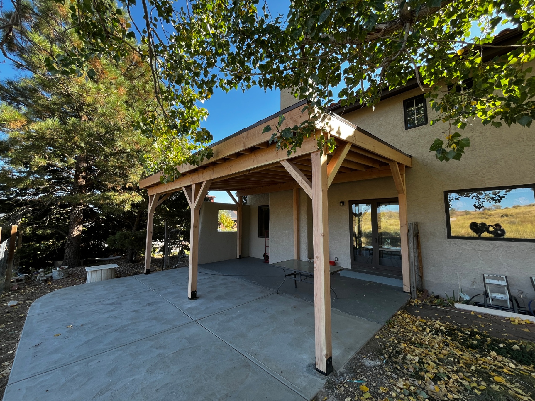 Finished cedar covered patio over stamped concrete with mountain views