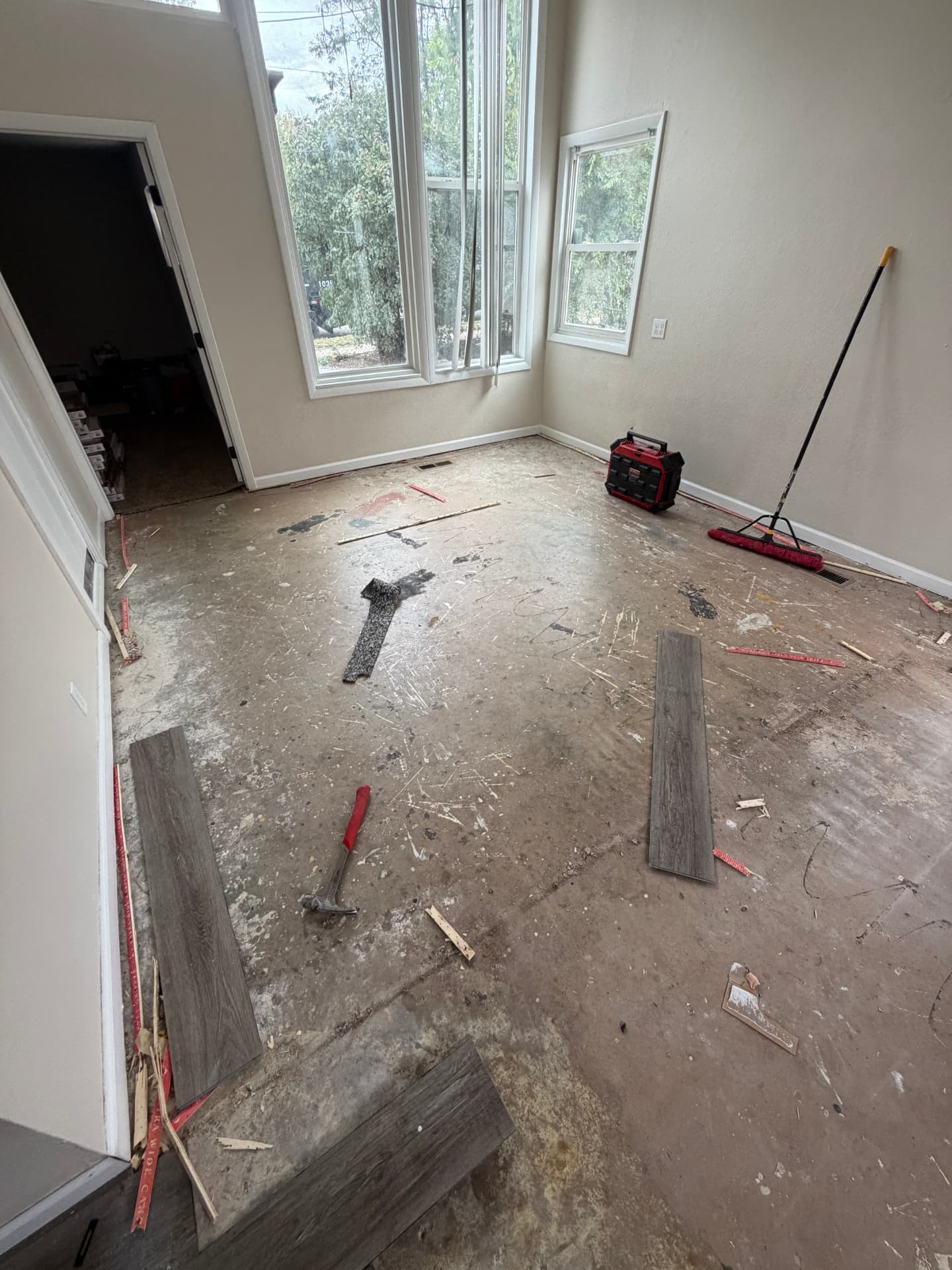 Tall-window living area flooring renovation — Before