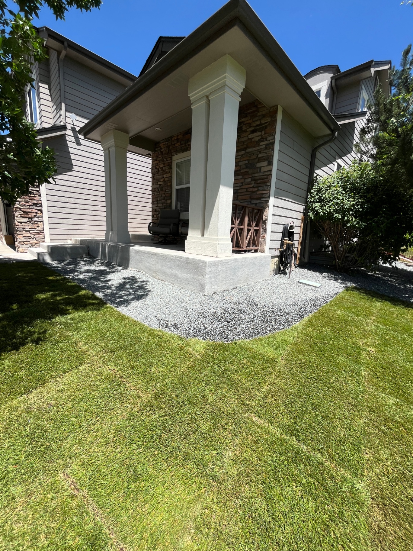 Completed front entry landscape refresh with fresh gravel border and clean lawn edge