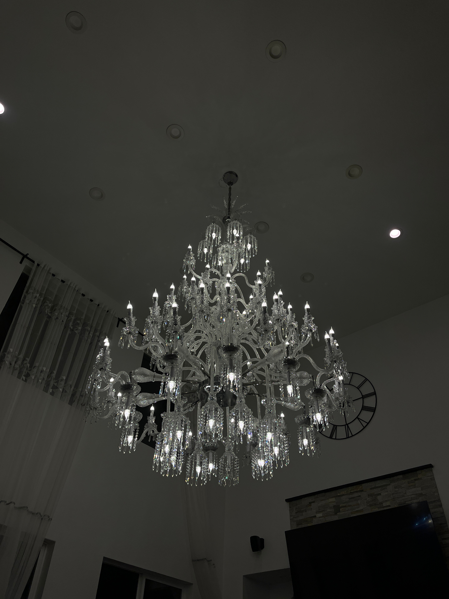 Close-up view of the illuminated crystal chandelier after installation