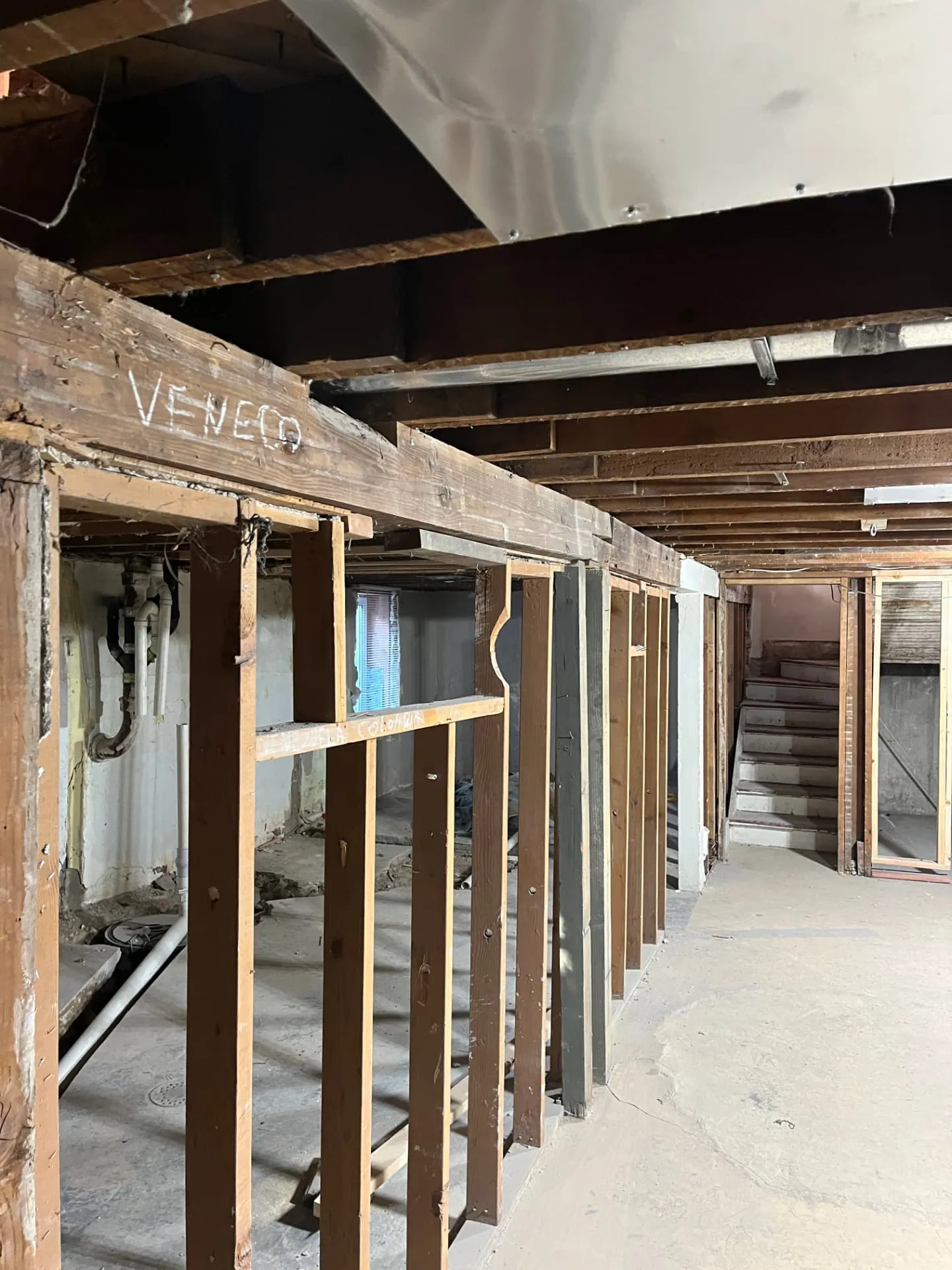 Demolition and temporary support framing before structural beam replacement
