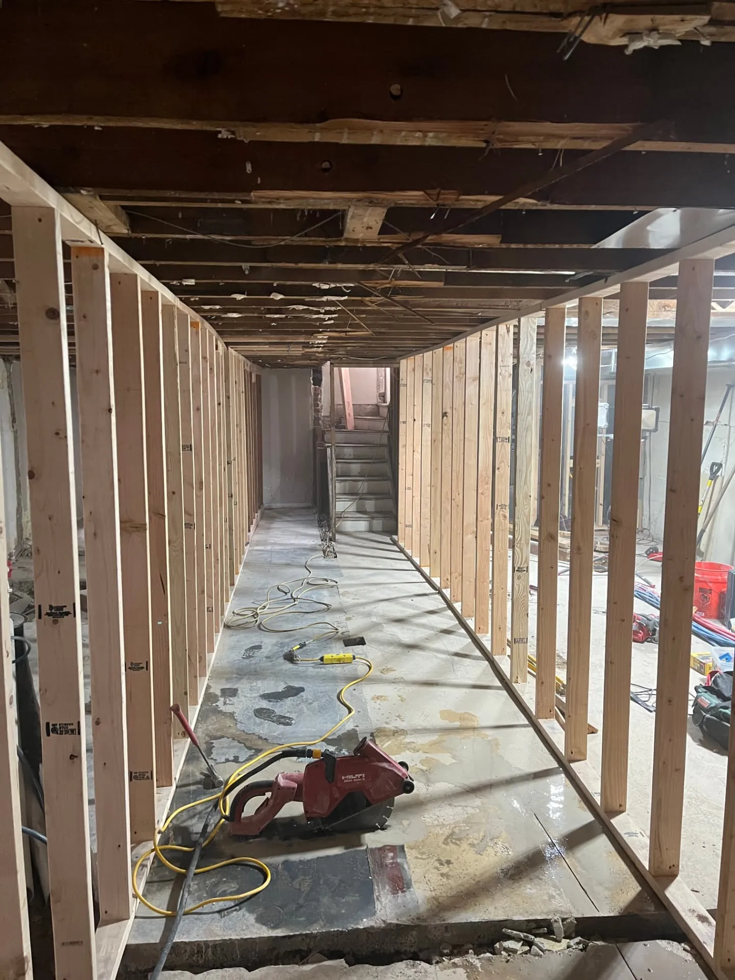 New stud framing forming a hallway during a lower-level remodel