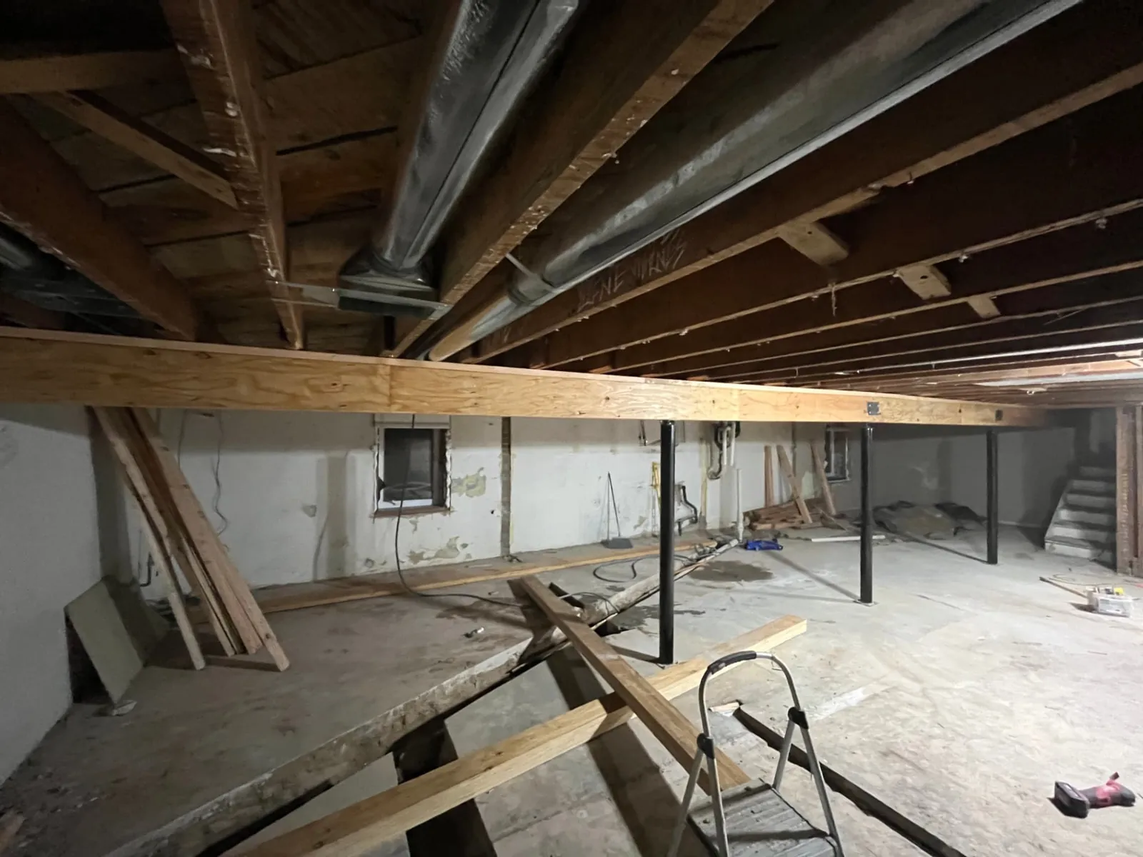 New engineered beam spanning the lower level on steel columns after joist repair