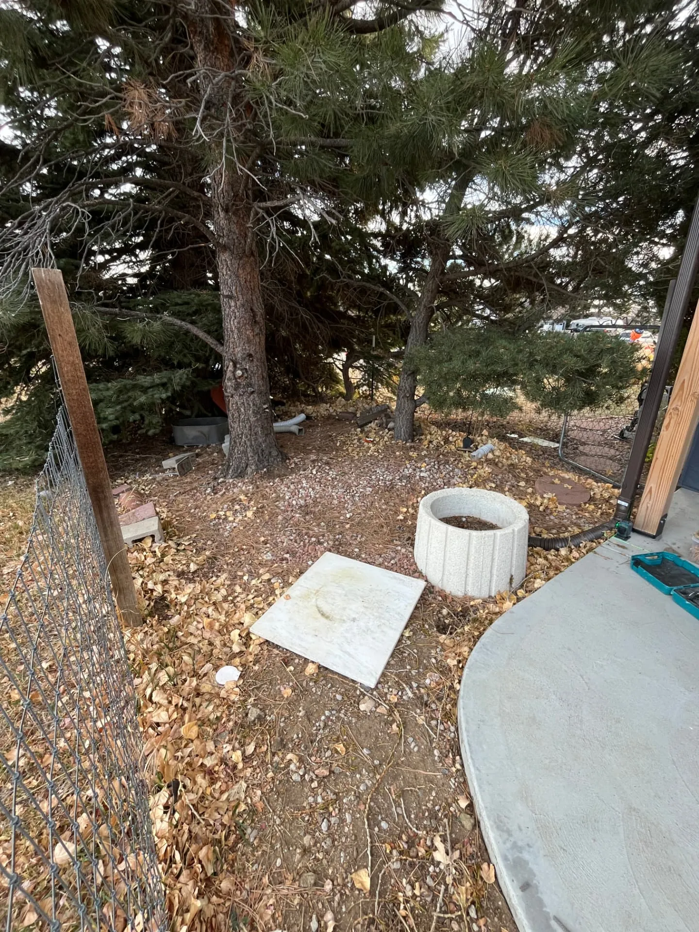 Backyard corner cleared and graded for a new deck before construction