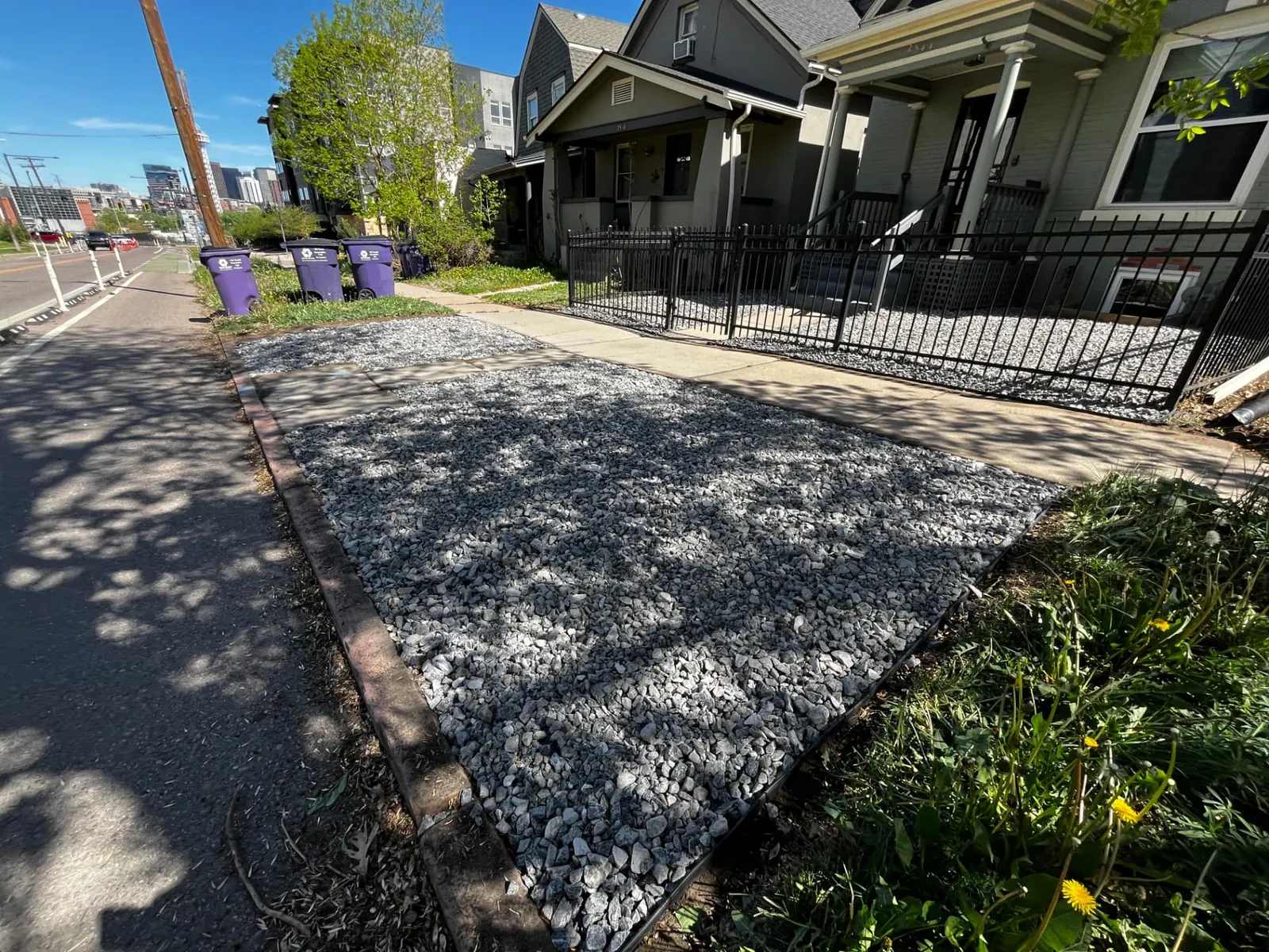 Gravel drainage strip with steel edging along a freshly graded curbside area in Denver