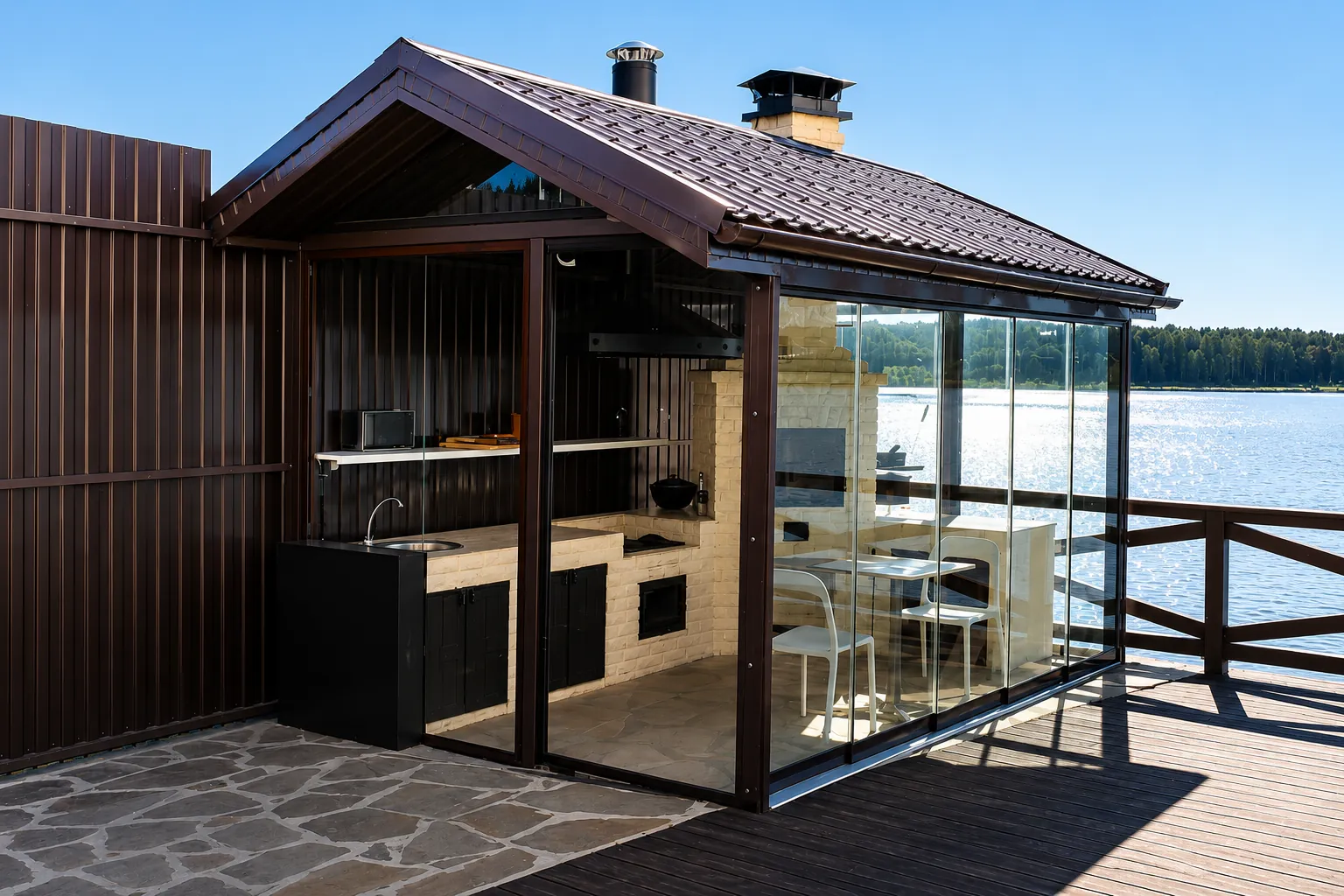 Lakeside outdoor kitchen with frameless sliding glass walls