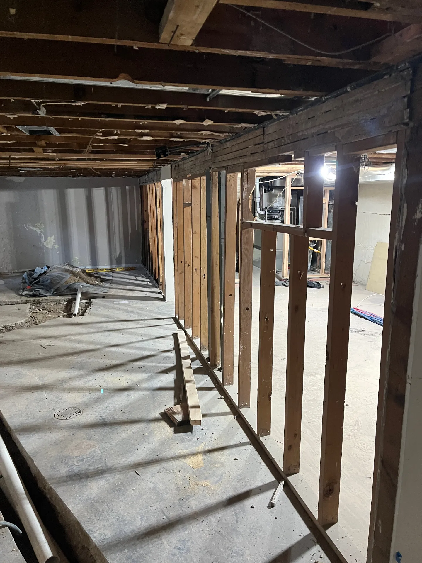 Basement before structural work with the original main beam and demolition underway