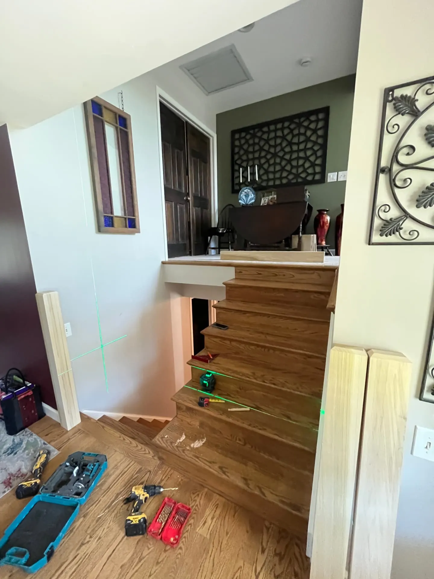 Laser layout for new newel posts and handrail during an interior stair rail replacement